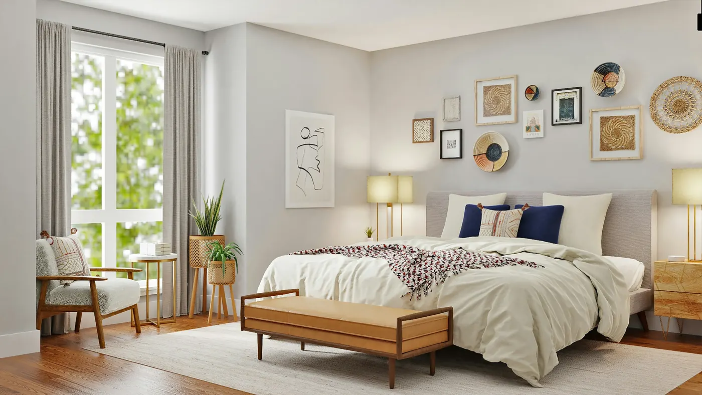 Primary bedroom with tall windows, a bench and a gallery wall